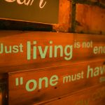 A rustic hand-painted wooden sign